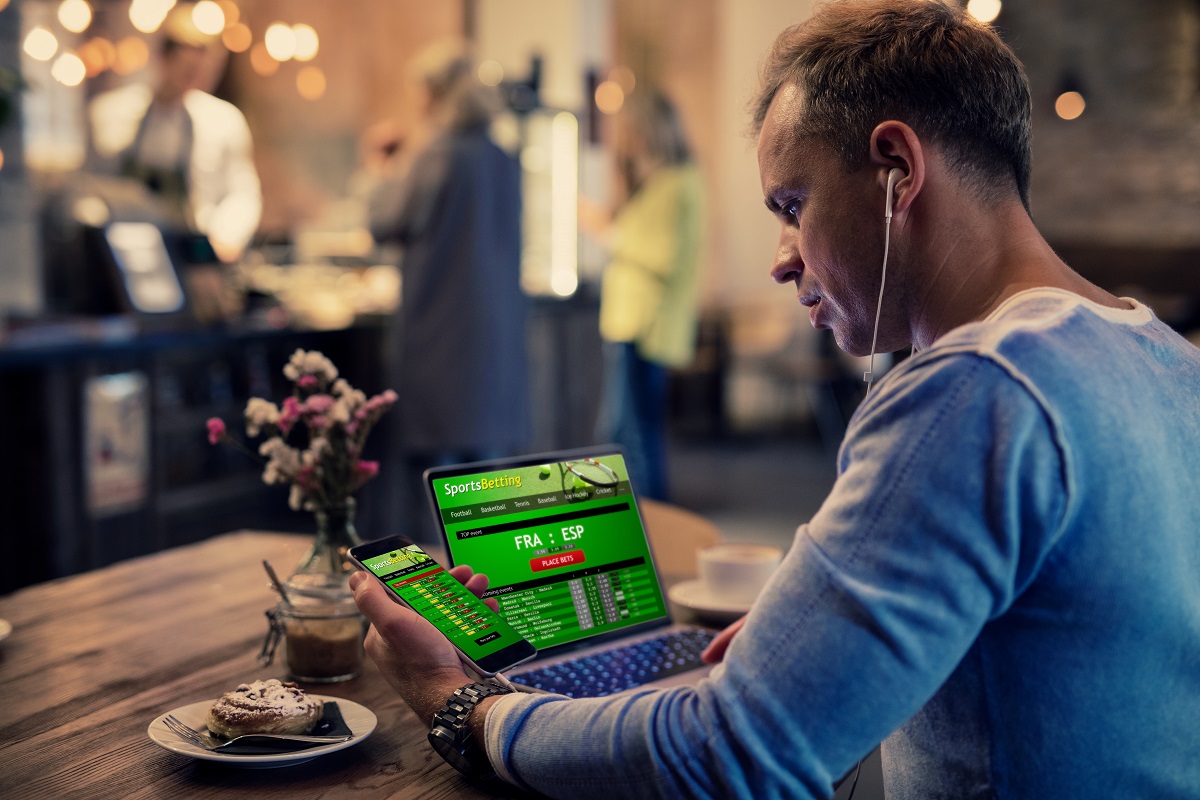 Man using computer to place bets