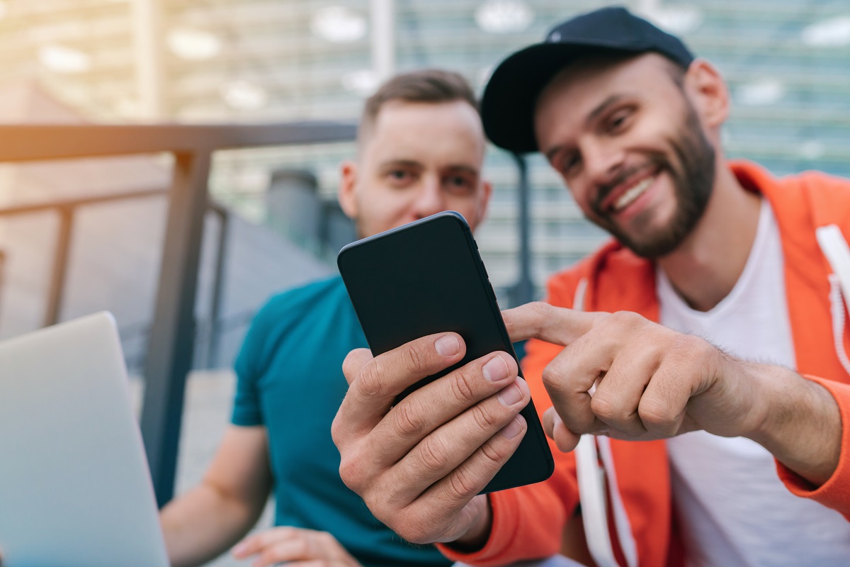 Two friends using phone